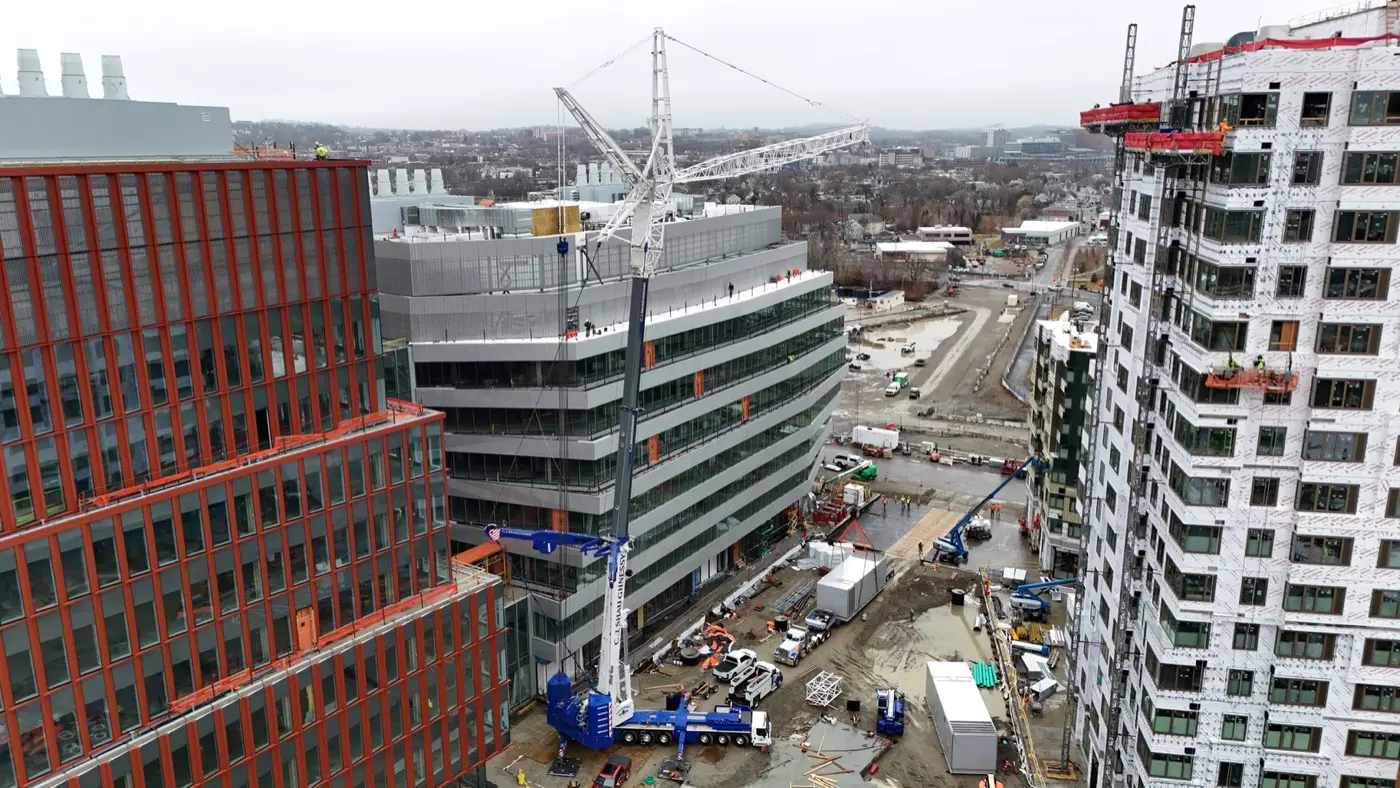 CJ Shaughnessy all-terrain crane setting a rooftop unit on a mid-rise building in Boston